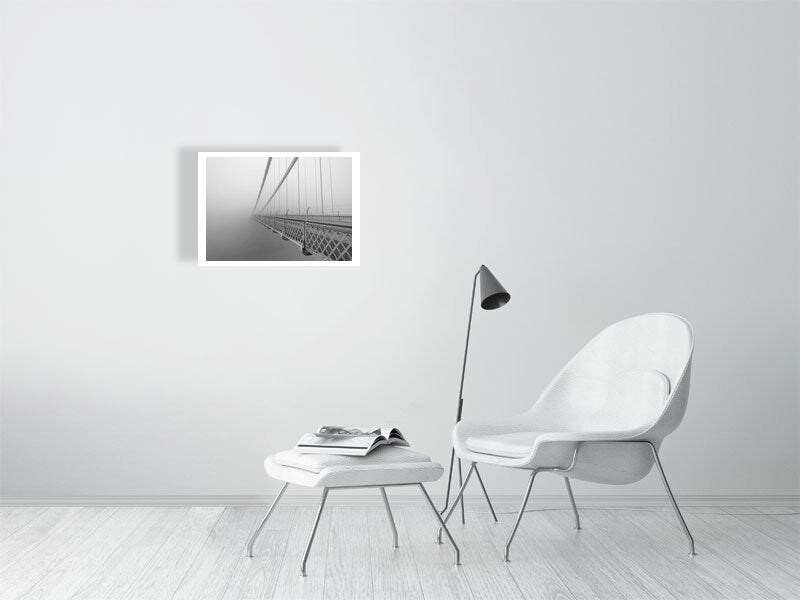 Print of Clifton suspension bridge in mist in black and white, shown against a brick wall