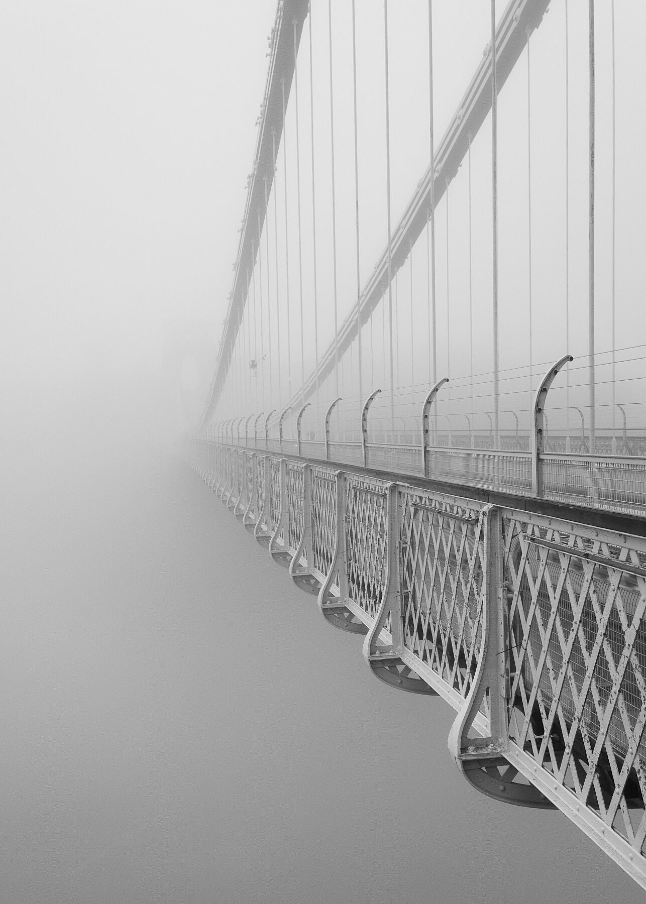 stunning black and white photograph captures the haunting beauty of one of the UK's most iconic landmarks, as it emerges mysteriously from a blanket of fog