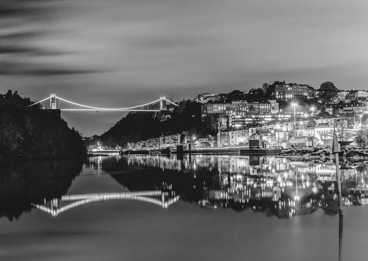 This black and white photograph captures ta beautiful view of Clifton and Brunel’s suspension bridge in central bristol, with a beautiful reflection in the river Avon. The early evening lights help give a range of tones