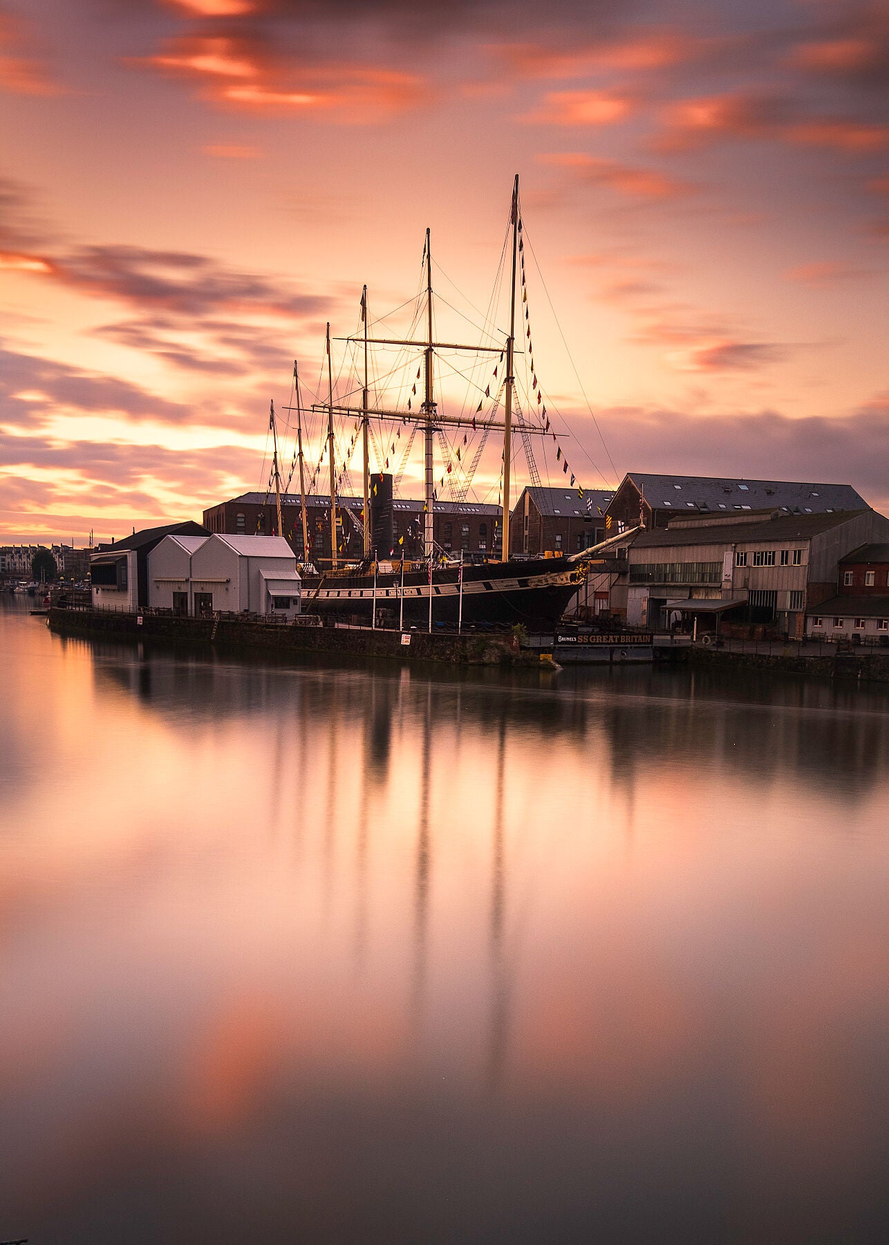 A stunning golden sunrise behind the SS Great Britain is reflected in the waters of Bristol's harbouside