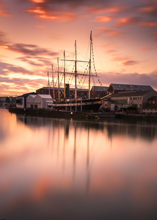 A stunning golden sunrise behind the SS Great Britain is reflected in the waters of Bristol's harbouside