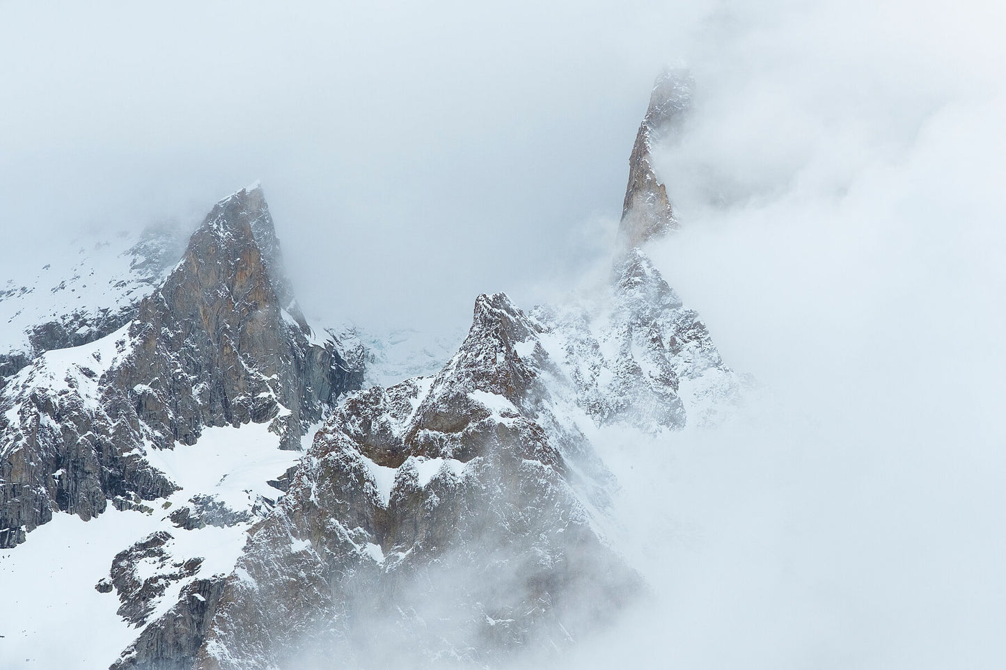 High cloud obscures a mountain peak in the Mont Blanc Massif above Courmayeur