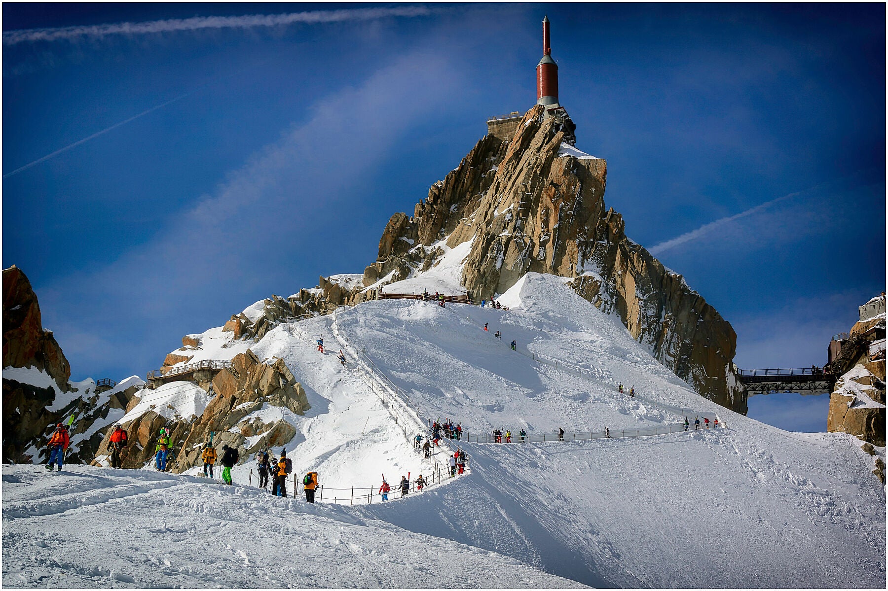 Like ants on the hillside, skiers the Aiguille du Midi make the precarious way to start the classic descent of the Vallee Blanche.