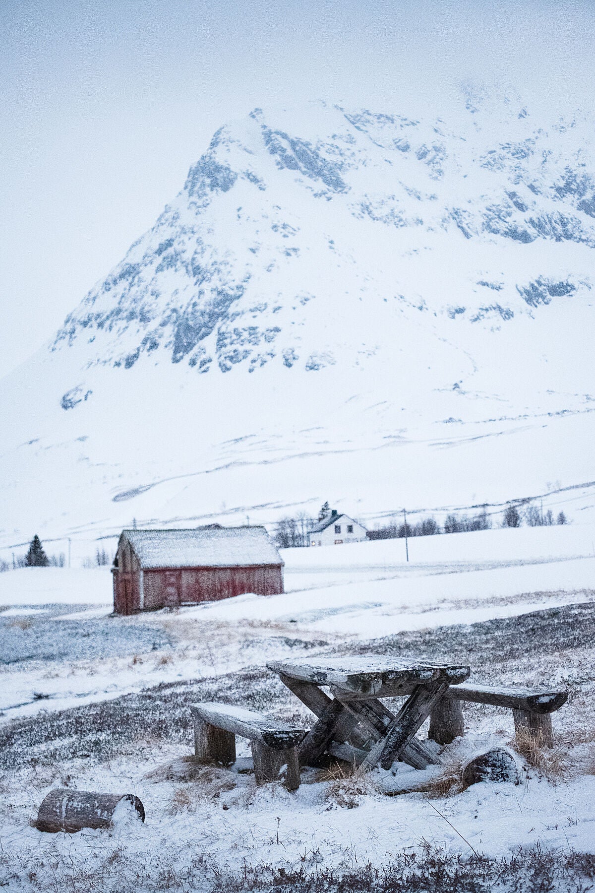 A picnic bench in a snowy scene on Kvaloya island, Norway