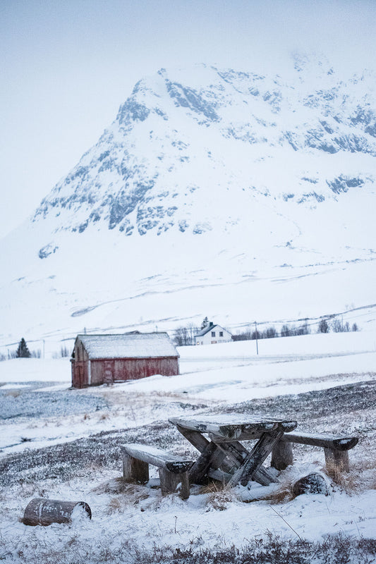 A picnic bench in a snowy scene on Kvaloya island, Norway