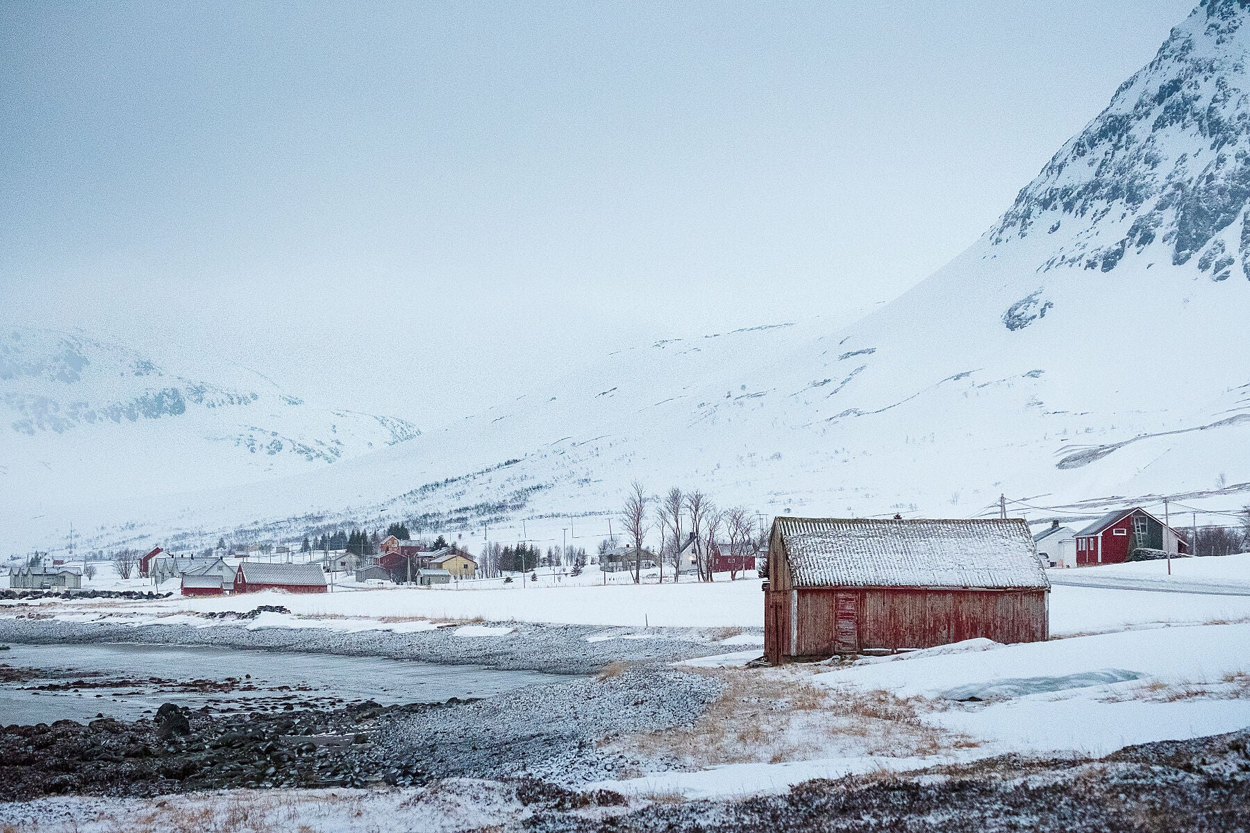 A bleak landscape with fishermans huts on the beach of Kvaloya fjord