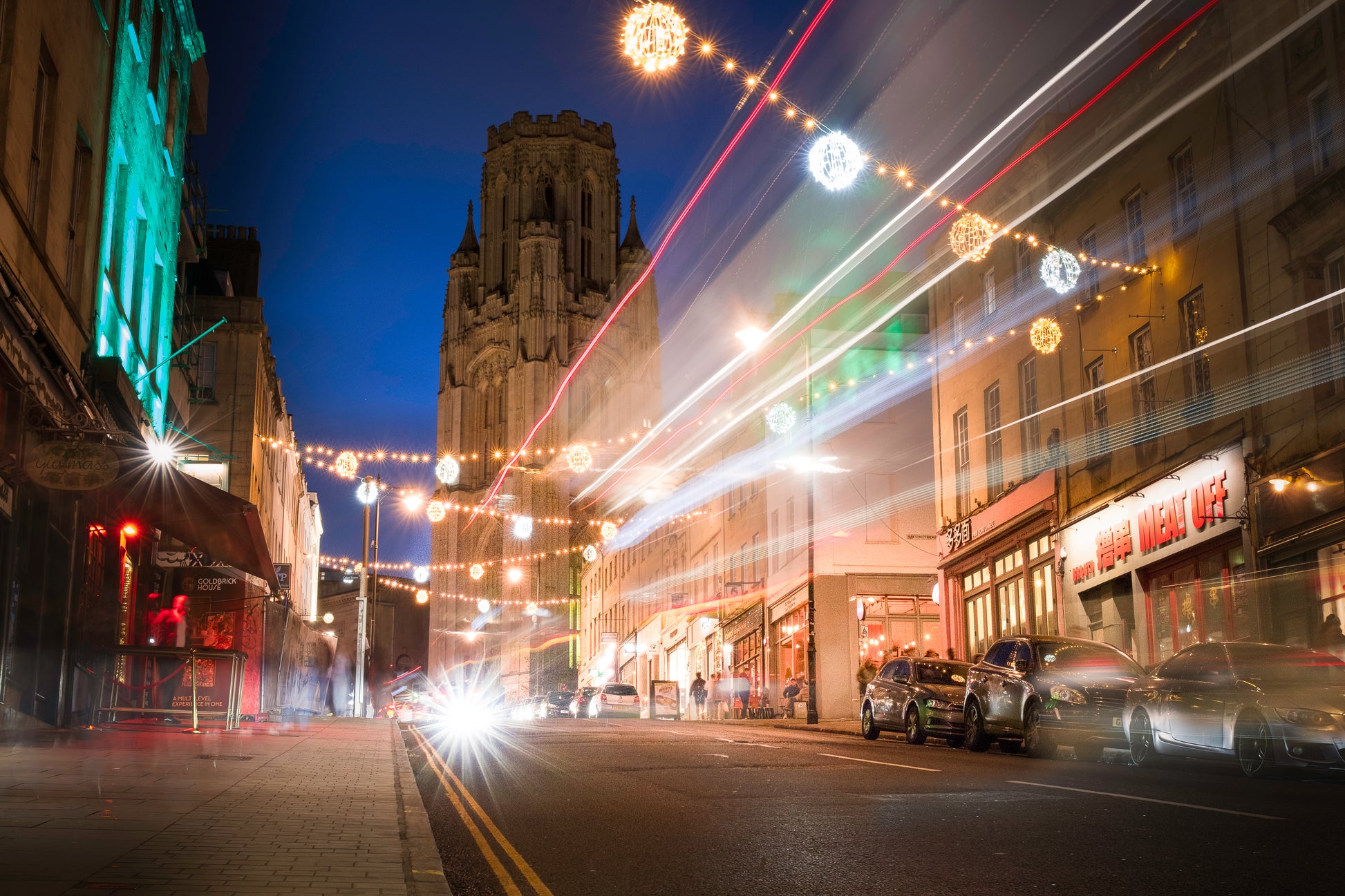 Christmas lights on Park street, Bristol, with car light trails towards the Wills Building