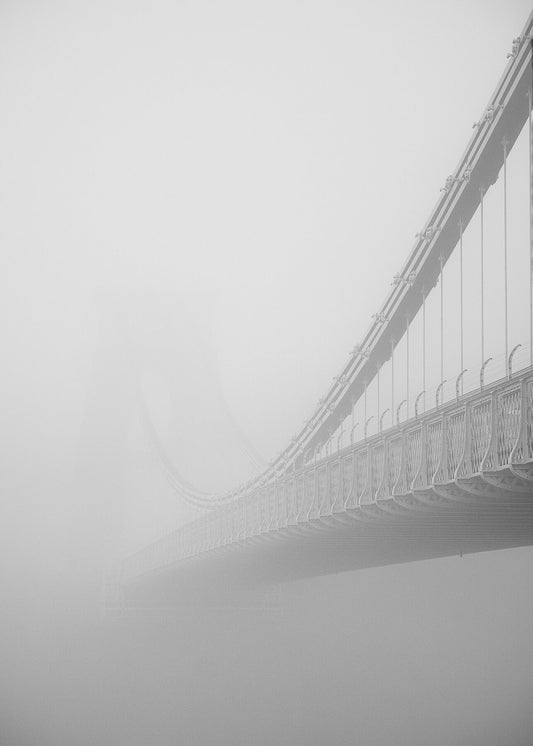 Black and white photo of  Clifton Suspension Bridge in Bristol receding into thick fog