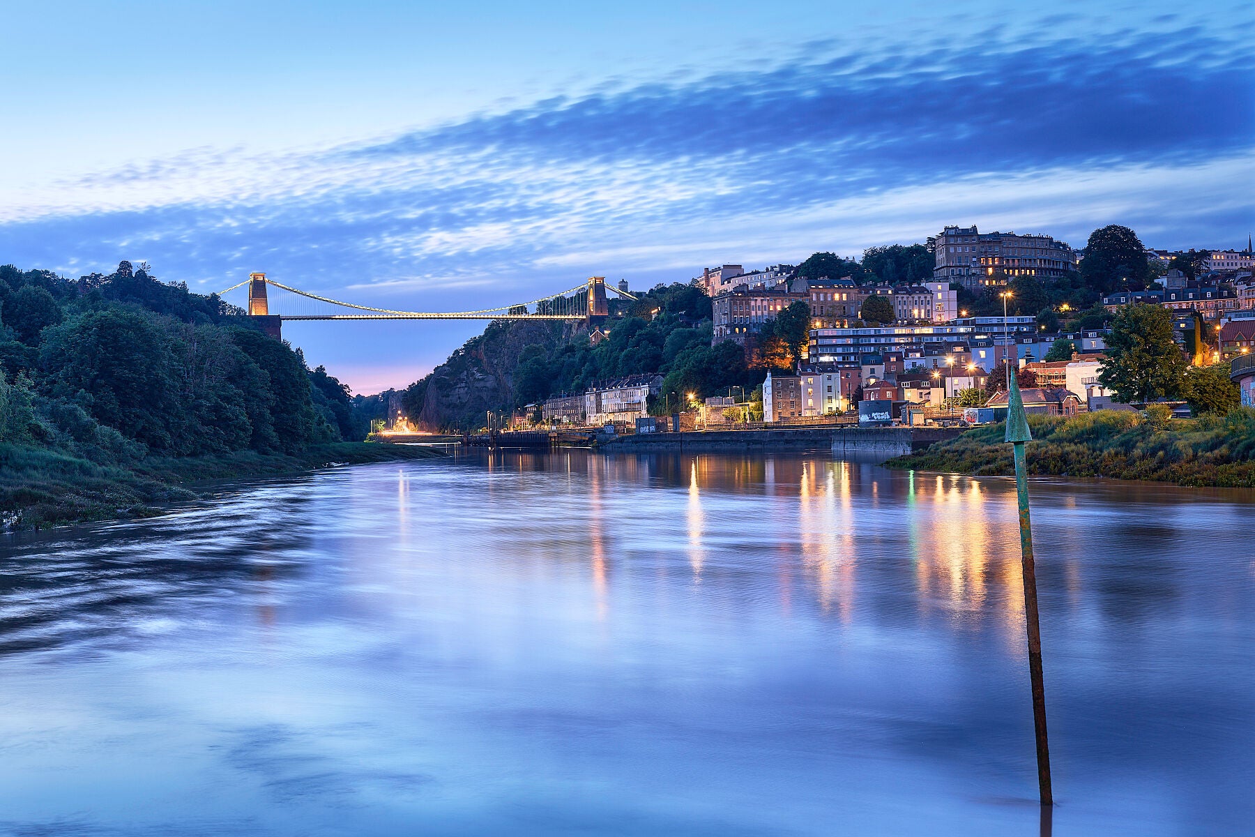 Wonderful early evening light falls on Clifton, the suspension bridge and the avon gorge at high tide in late summer.