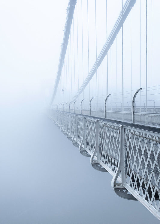 Beautiful colour  high resolution photo of Clifton Suspension Bridge receding into thick fog toward the light breaking through in the distance