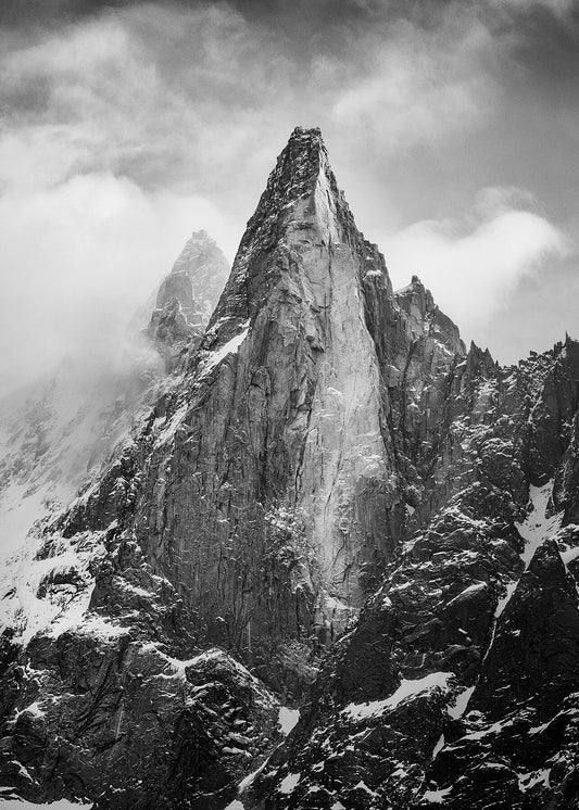 Les Drus mountains near Chamonix in the Mont Blanc Massif, with dramatic clouds swirling around the peak
