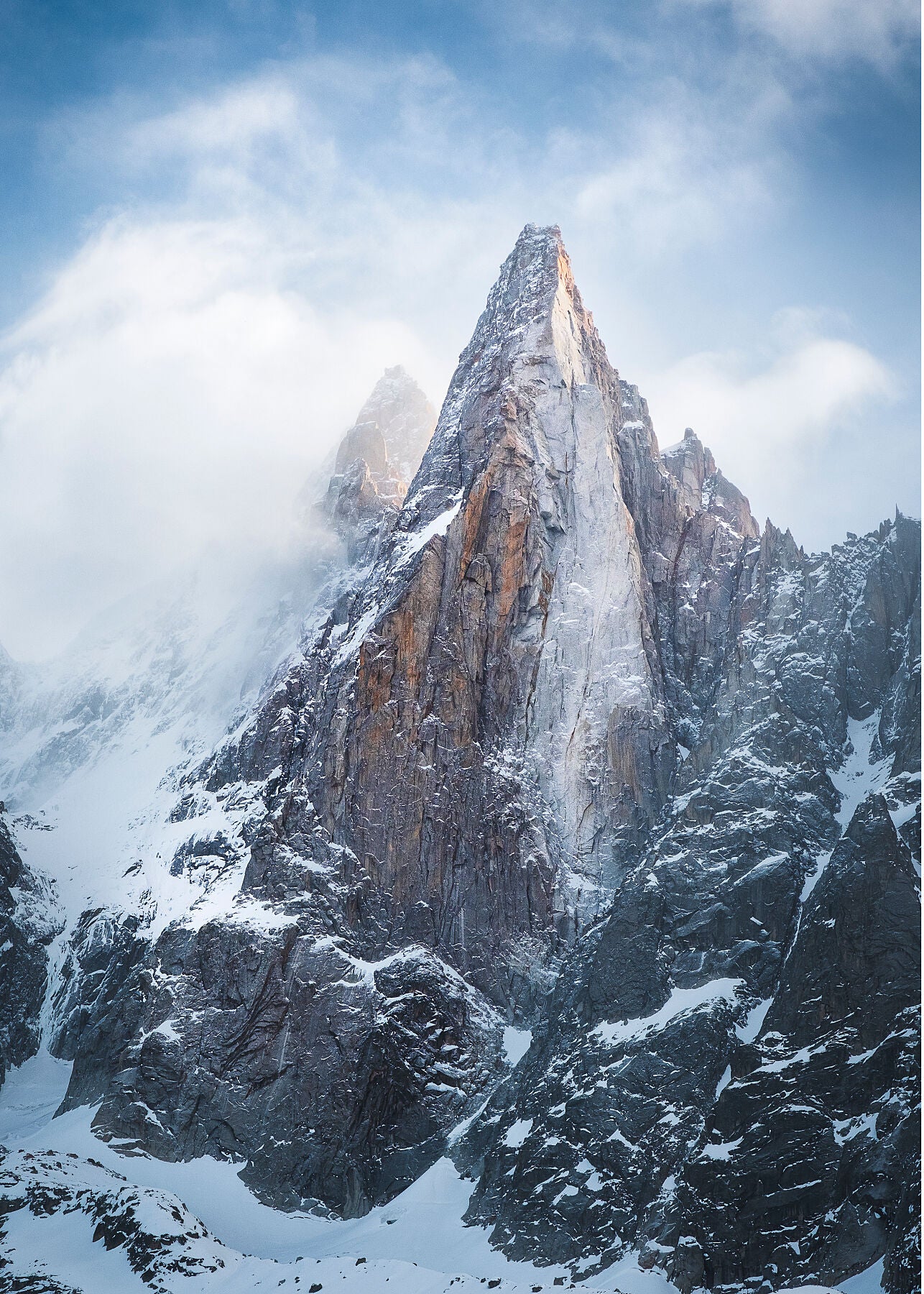 Dramatic Clouds swirl around the mountain peak of Les Drus in the Mont Blanc Massif