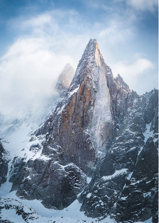 Dramatic Clouds swirl around the mountain peak of Les Drus in the Mont Blanc Massif