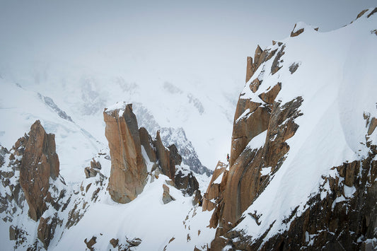 Climbers laden with touring skis start to ascend the Arête des Cosmiques in the Mont Blanc Massif above Chamonix