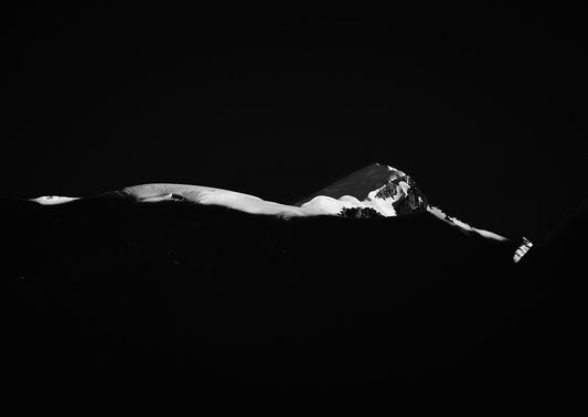 The summit of Mont Blanc, with sunlight lighting in a minimalist fine alpine scene of the Mont Blanc Massif