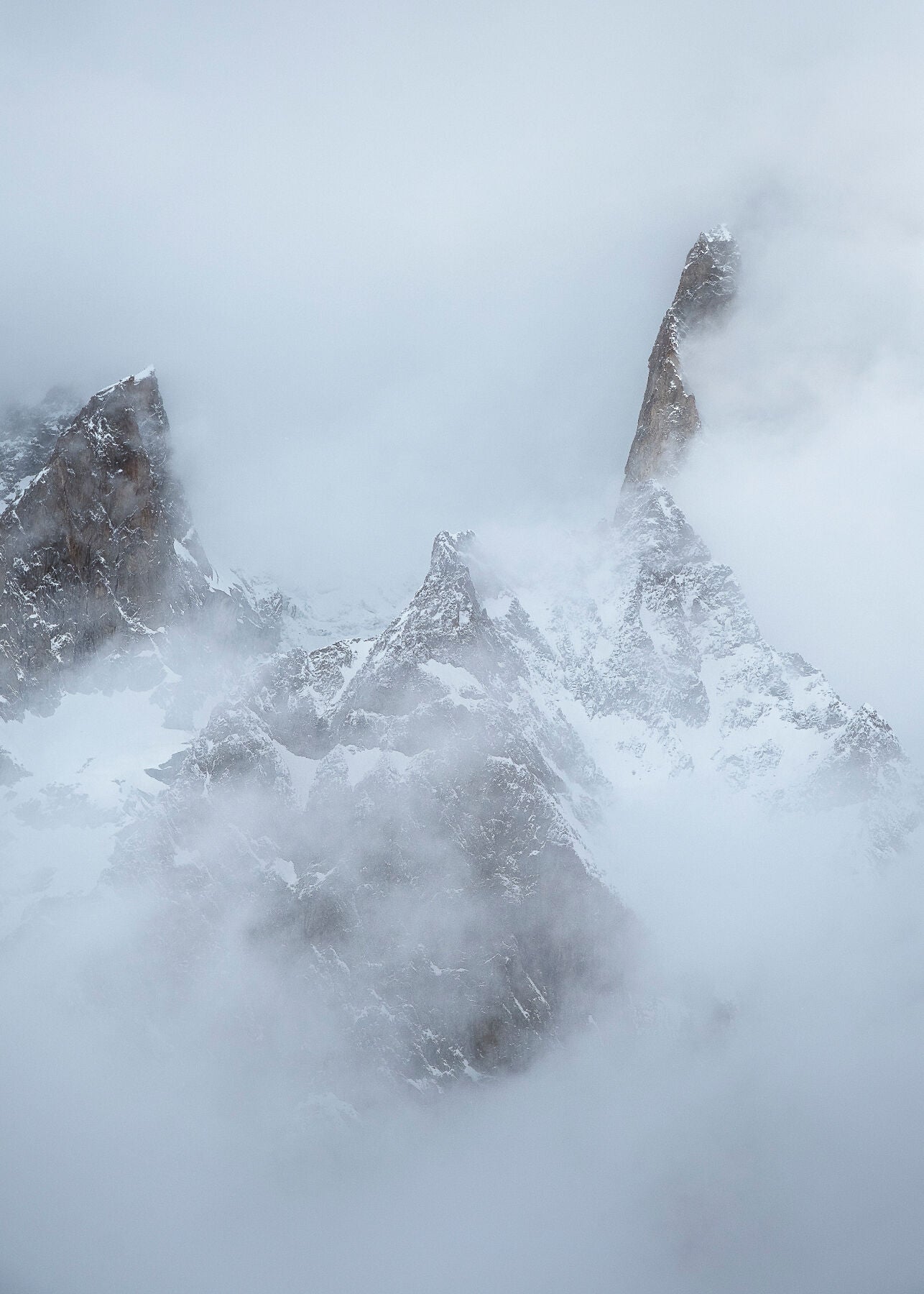 Cloud swirls around the high mountain peaks above Courmayeur in the Mont Blanc Massif