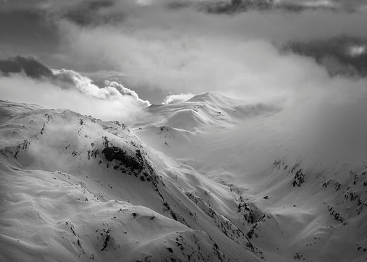 snowy mountains with swirling clouds above les Contamines in the Mont Blanc Massif