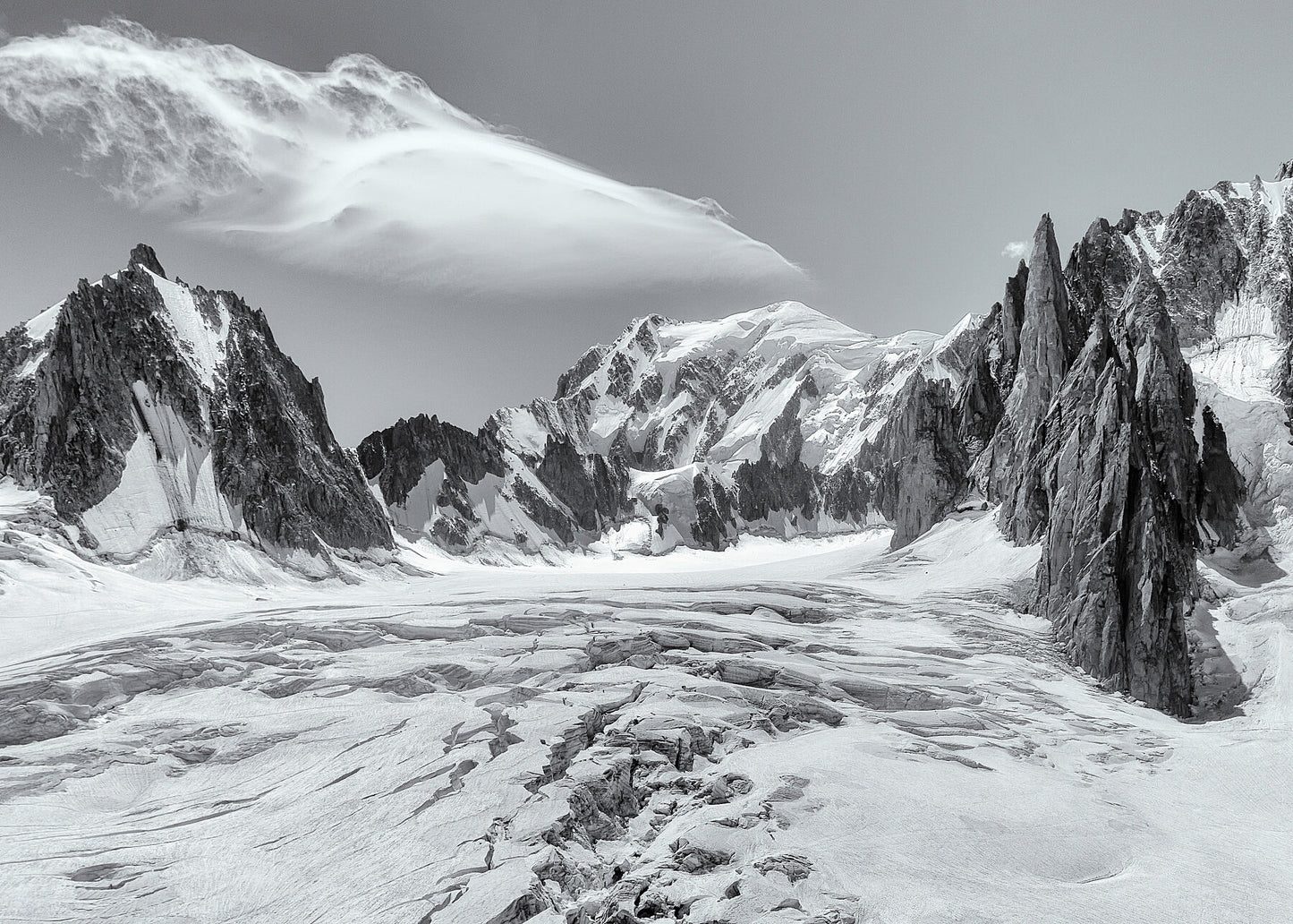 The view over a glacier towards the summit of Mont Blanc above Chamonix in the French Alps, with dramatic peaks and a beautiful cloud