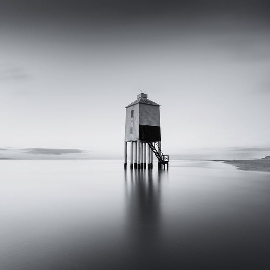 High tide sweeps past the Burham low lighthouse in the severn estuary, which stands isolated and proud in this beautiful black and white photograph