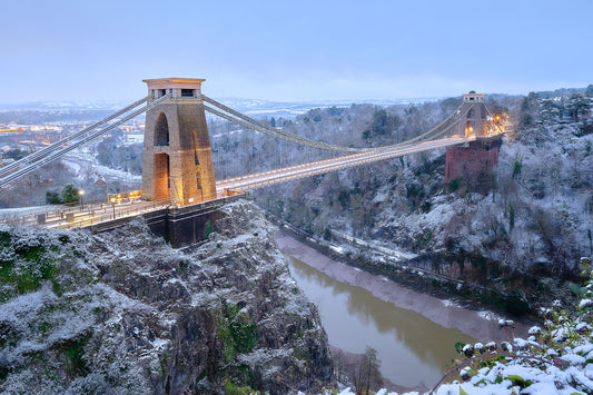 Snow peppers the ground in this photograph of Brunel’s Clifton suspension bridge above the Avon gorge in Bristol