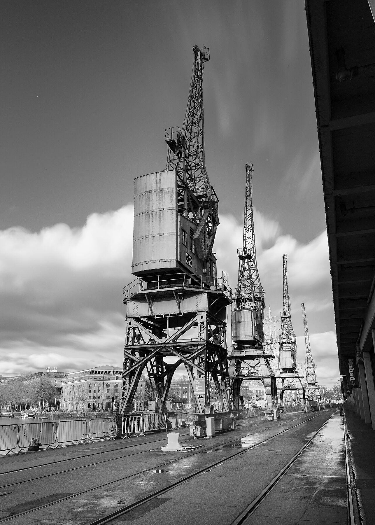 This black and white photograph captures the 3 iconic and historic Bristol city Cranes on the harbourside