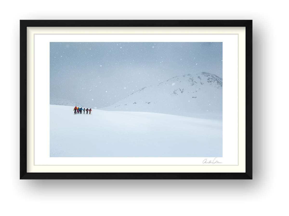 Ski Tourers battle the fall of winter: Snow Flurries on high — framed
