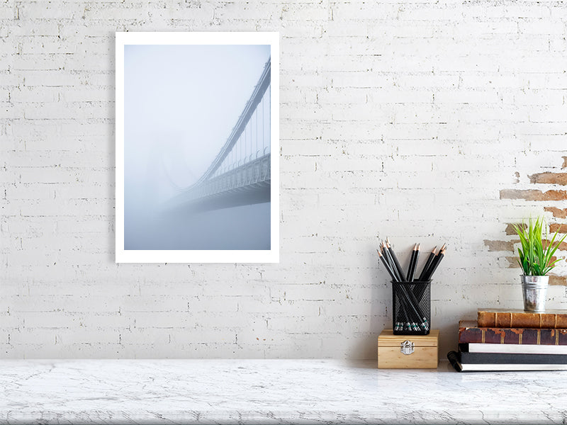 Print of Clifton Suspension Bridge in Bristol just visible through thick fog pictured on a brick wall