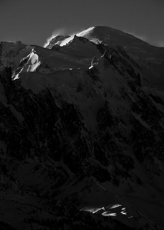 Mountain landscape of the Chamonix valley towards the summit of Mont Blanc, with the Aiguille duMidi lift station just visible in front of the summit itself. 