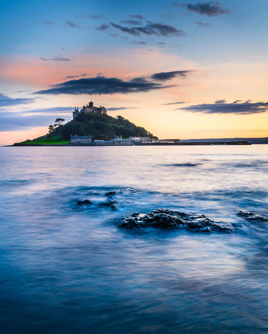 Stunning sunset colours form the backdrop to St Michael's Mount in Cornwall with a tranquil sea