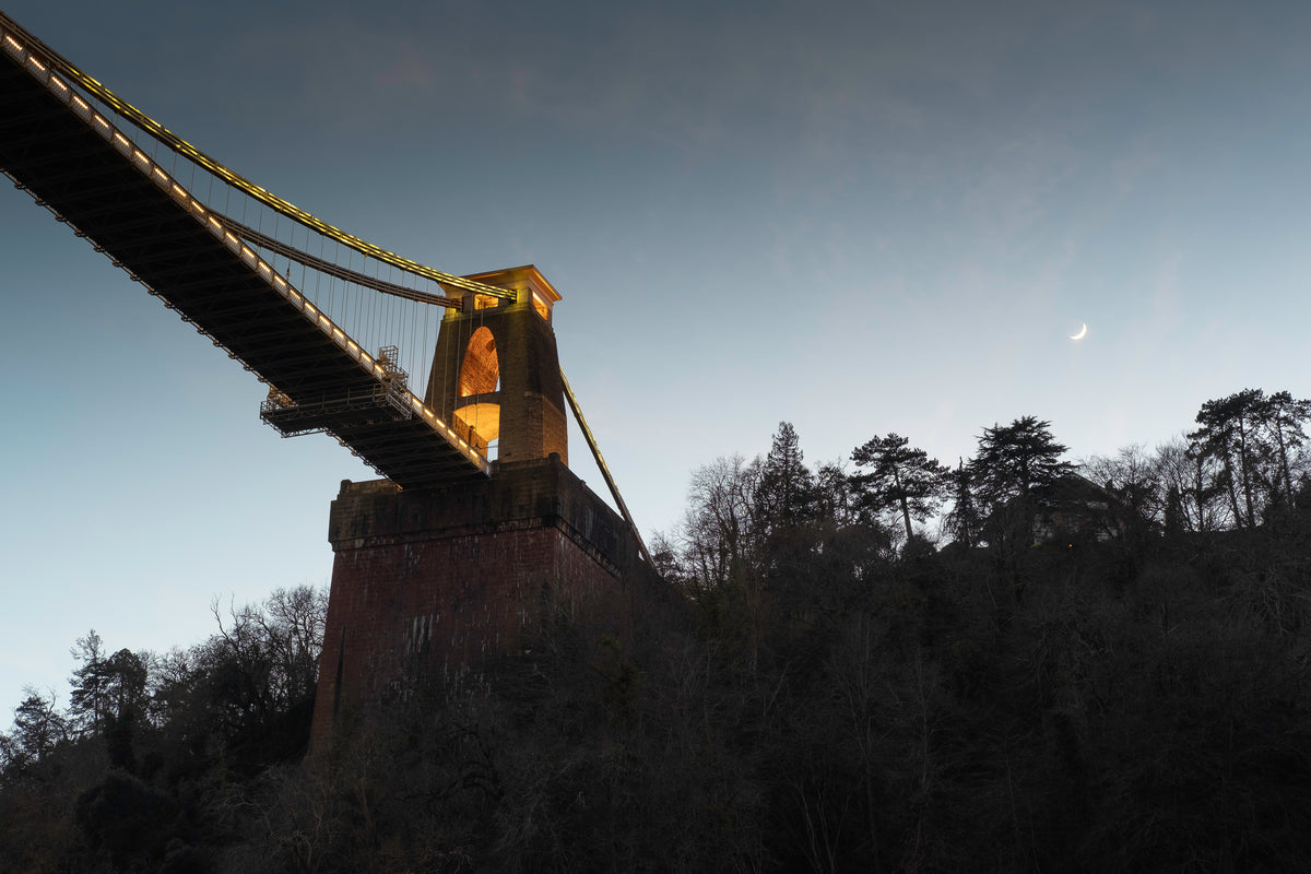 Clifton suspension bridge from underneath with the moon above