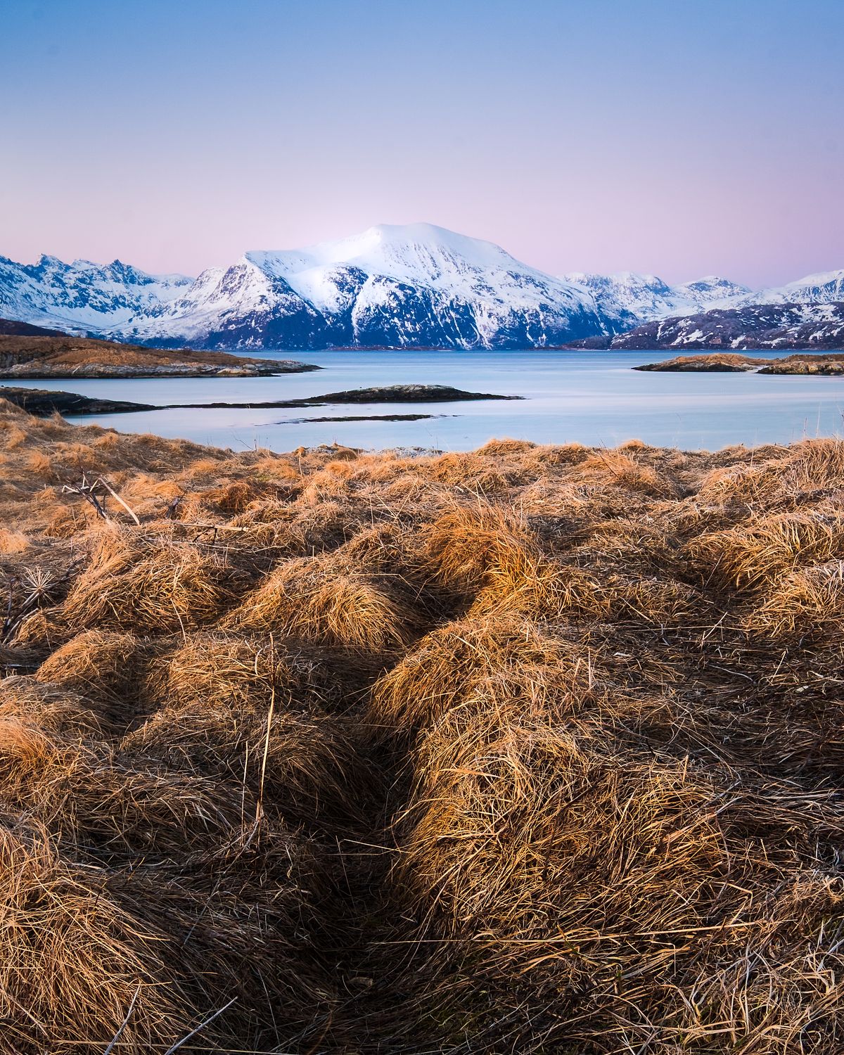 Snow Covers Mountains at Sunset, Norway