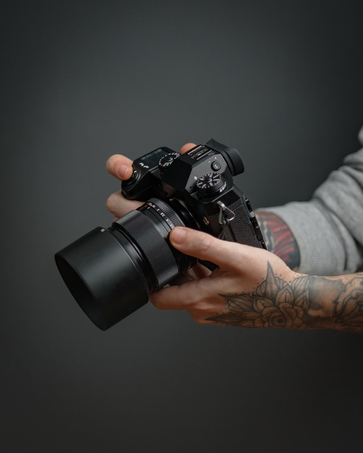 Hands holding a camera to adjust settings